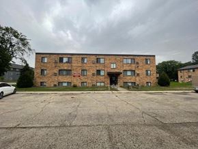 Fargo apartment for rent - a large brick building with a parking lot