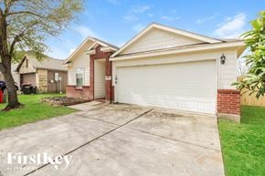 Baytown house for rent - A house with a white garage door is for sale.