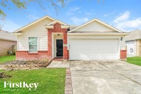 Baytown house for rent - A house with a red brick pillar and a black door.