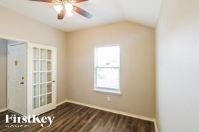 Baytown house for rent - A room with a ceiling fan and a window with blinds.