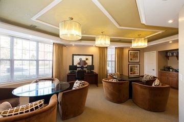 Orlando apartment for rent - A living room with a glass table and brown chairs.