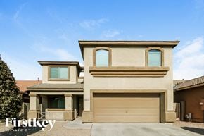 Tolleson house for rent - a tan house with two garage doors