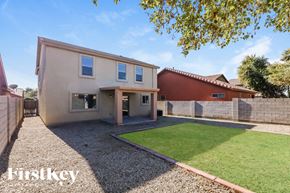 Tolleson house for rent - a house with a grass lawn and a fence