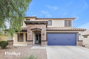 Surprise house for rent - A house with a blue garage door is for sale.