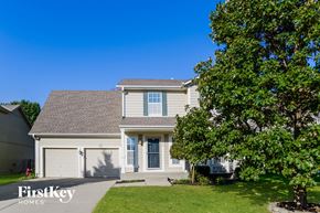 Olathe house for rent - A house with a tree in front of it.
