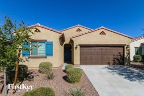 Buckeye house for rent - a house with a garage door and a driveway