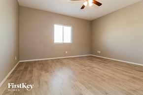 Buckeye house for rent - the spacious living room with wood flooring and a ceiling fan