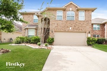 Spring house for rent - a large brick house with a driveway and a garage door
