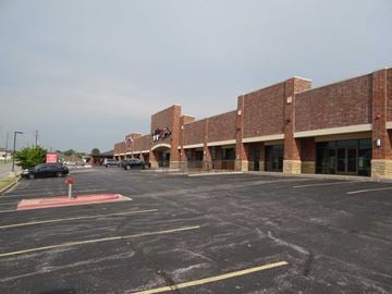 Joplin apartment for rent - a parking lot in front of a brick building
