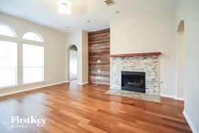 Bacliff house for rent - a living room with a fireplace and a wooden floor