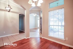 Bacliff house for rent - an empty living room with a large window and hardwood floor