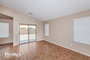 Avondale house for rent - an empty living room with a sliding glass door to a patio