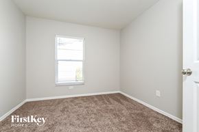 Valrico house for rent - a bedroom with a carpeted floor and a window