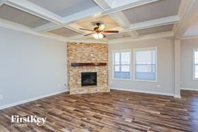 Gainesville house for rent - A room with a fireplace and wooden floors.