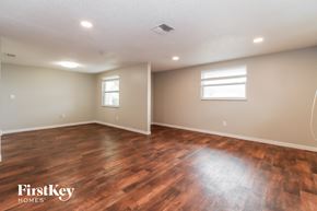 Port Richey house for rent - the spacious living room with hardwood flooring and a window
