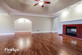 Loganville house for rent - a living room with a fireplace and a hard wood floor