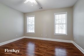Loganville house for rent - the second bedroom with hardwood flooring and two windows
