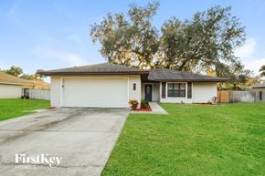 Edgewater house for rent - a white house with a lawn and a driveway