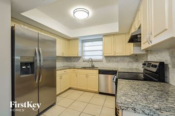 Edgewater house for rent - a kitchen with granite counter tops and stainless steel appliances