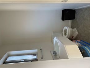 Hayfork apartment for rent - A bathroom with a toilet, sink, and a black device mounted on the wall.