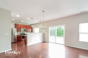 Durham house for rent - A spacious kitchen with wooden cabinets and a refrigerator.