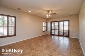 Mesa house for rent - A spacious room with a ceiling fan and tiled floor.