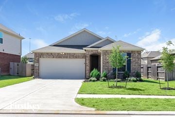 Richmond house for rent - a house with a garage door in front of a lawn