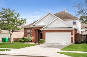Seabrook house for rent - a brick house with a white garage door