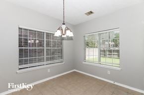 Seabrook house for rent - a dining room with two windows and a chandelier