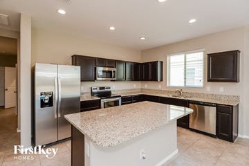 San Tan Valley house for rent - a kitchen with granite counter tops and stainless steel appliances