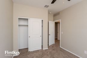 San Tan Valley house for rent - a bedroom with two closets and a hallway with two doors