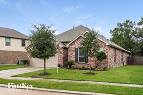 Humble house for rent - a house with a lawn and trees in front of it