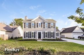 Charlotte house for rent - A house with a white picket fence and a car parked in the driveway.