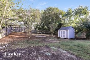 Charlotte house for rent - A backyard with a shed and trees.