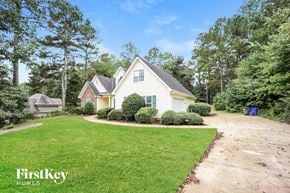 Fayetteville house for rent - A house with a well-maintained lawn and trees in the background.