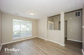 Fayetteville house for rent - A room with wooden floors and a window with blinds.