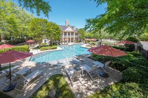 Columbus apartment for rent - A large house with a pool and patio furniture.
