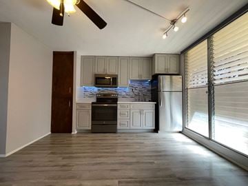 Honolulu apartment for rent - A kitchen with a refrigerator, oven, and microwave.