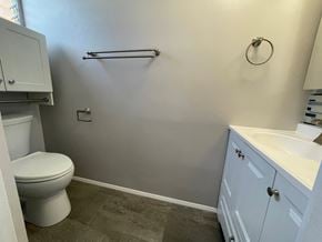 Honolulu apartment for rent - A bathroom with a toilet, sink, and towel rack.
