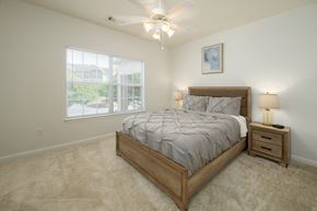 Columbus apartment for rent - A bedroom with a large bed and a ceiling fan.