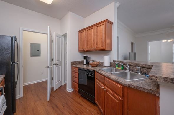 Columbus apartment for rent - A kitchen with wooden cabinets and a black refrigerator.