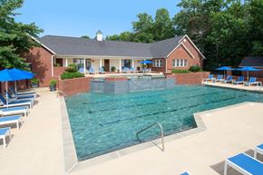 Columbus apartment for rent - A pool with a diving board and a house in the background.