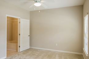 Columbus apartment for rent - A room with a ceiling fan and a door leading to another room.