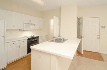 Columbus apartment for rent - A kitchen with white cabinets and appliances.