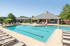 Columbus apartment for rent - A large swimming pool with sun loungers and a pavilion in the background.