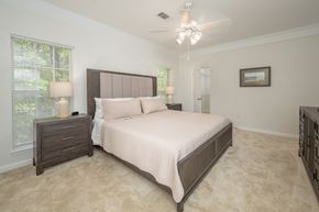Columbus apartment for rent - A bedroom with a large bed and a ceiling fan.
