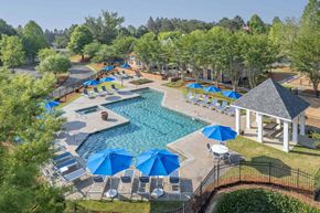 Columbus apartment for rent - A pool surrounded by blue umbrellas and chairs.