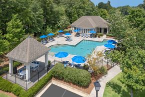 Columbus apartment for rent - A pool surrounded by trees and a gazebo.