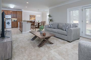 Columbus apartment for rent - A modern living room with a grey couch and a wooden coffee table.