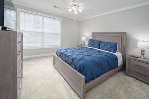 Columbus apartment for rent - A bedroom with a large bed and a ceiling fan.